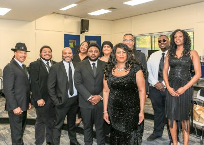 A group of people in suits and ties standing next to each other.