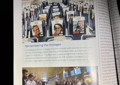 Tribute event at an airport with people standing solemnly in two lines, and an airplane cabin with photos on each seat commemorating hostages.