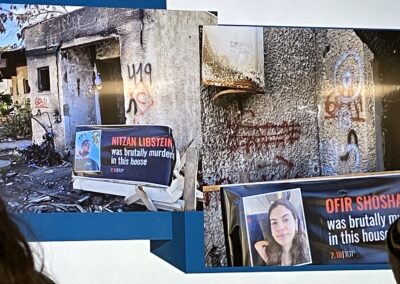 A damaged building with memorial signs stating that individuals were brutally murdered at the location.