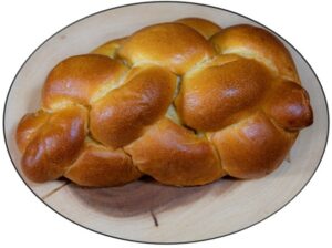 A loaf of bread on a plate sitting on top of a table.